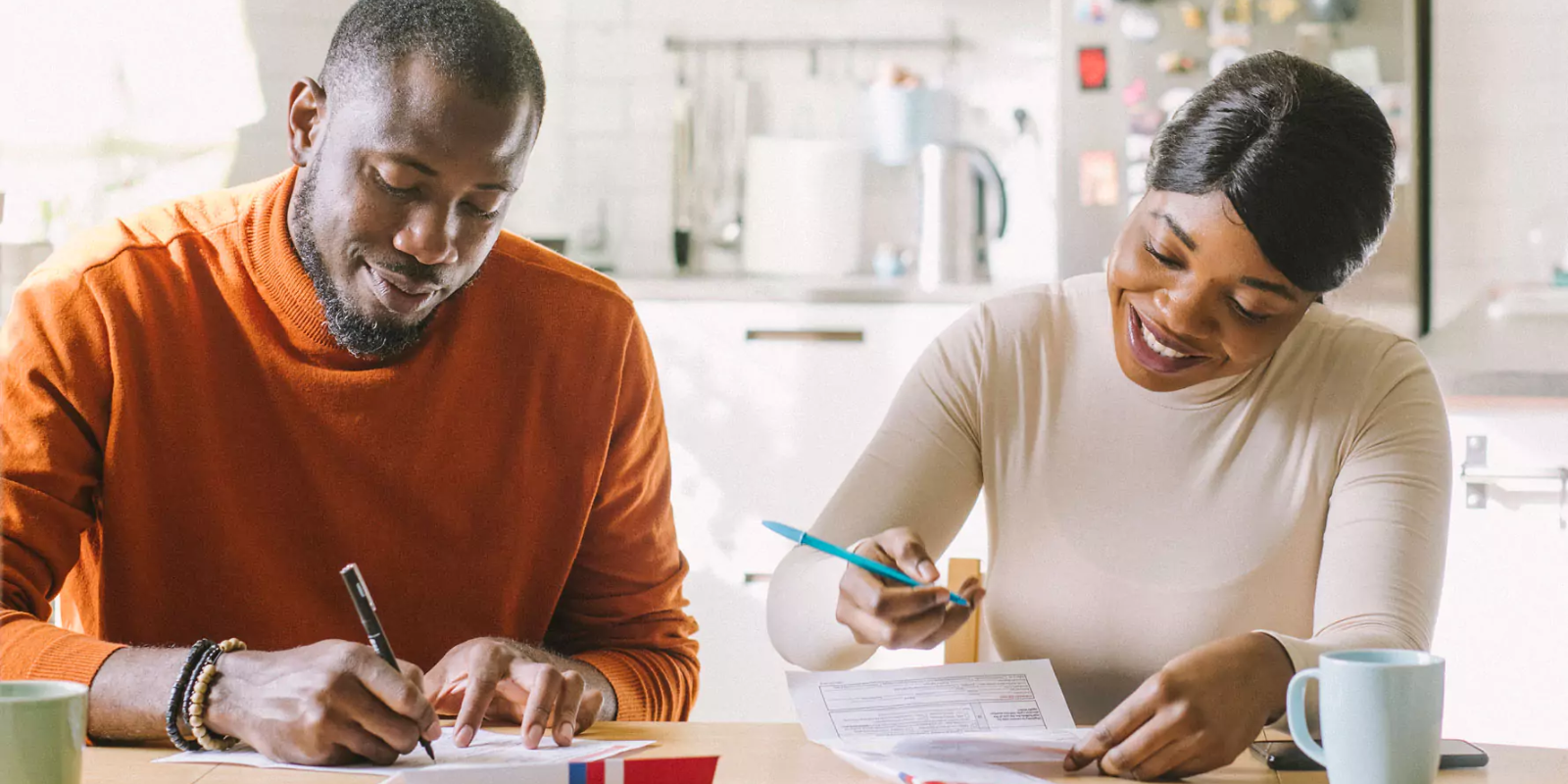 Two African American people voting at their kitchen table