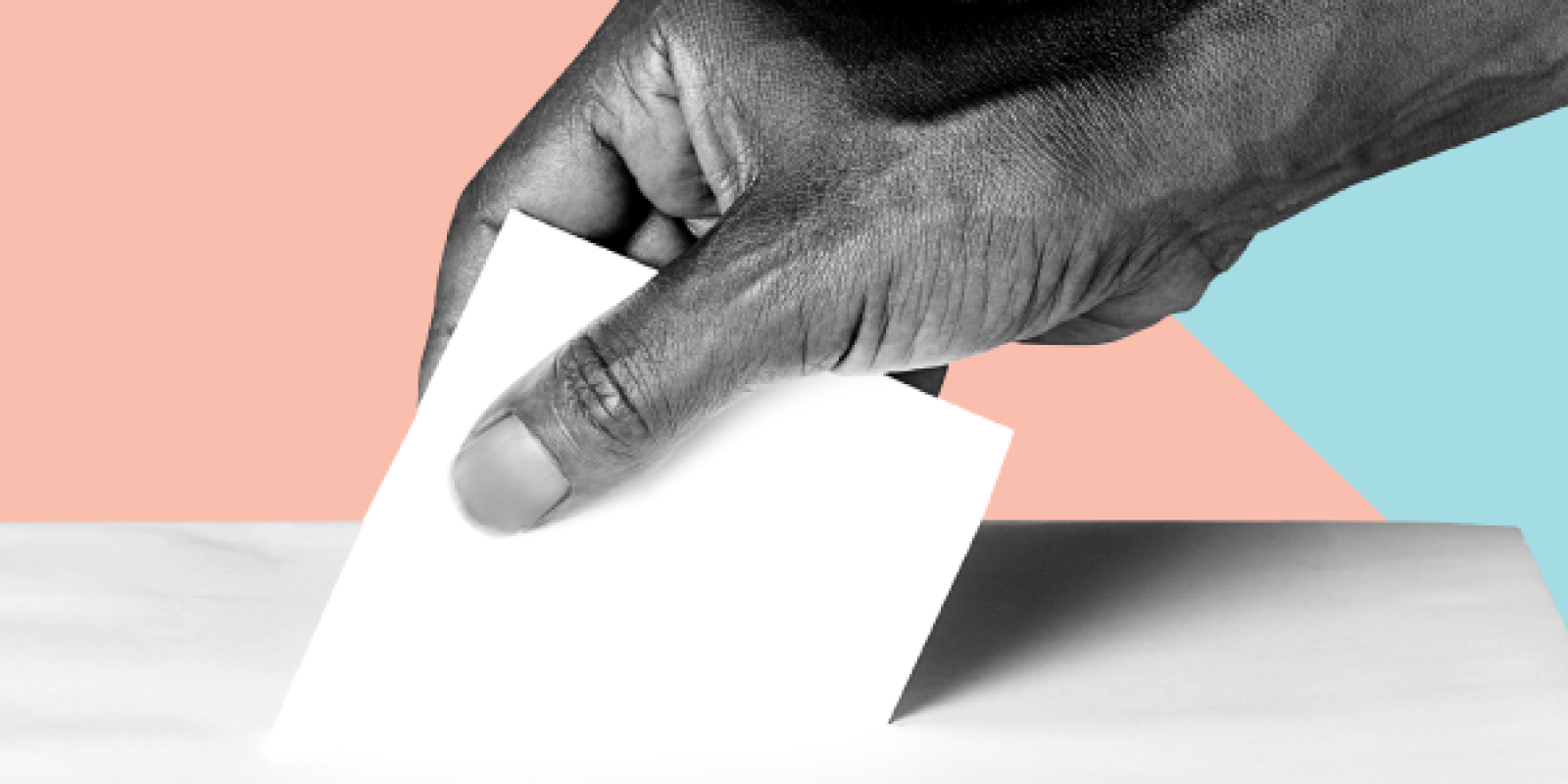 Hand placing ballot in box.