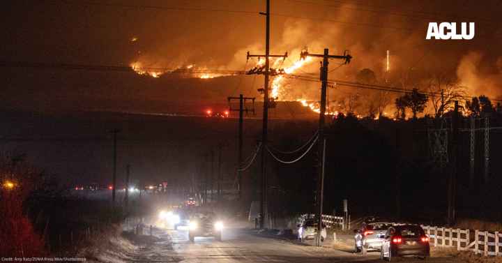 Hughes fire, in Castaic, burns on a hill threatening the freeway below while cars attempt to escape.