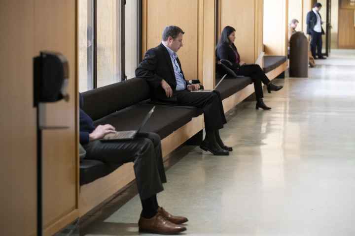 Legislators sitting down and waiting