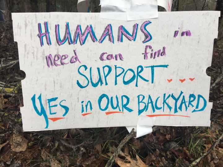 sign reads: Humans in need can find support...yes, in our backyard
