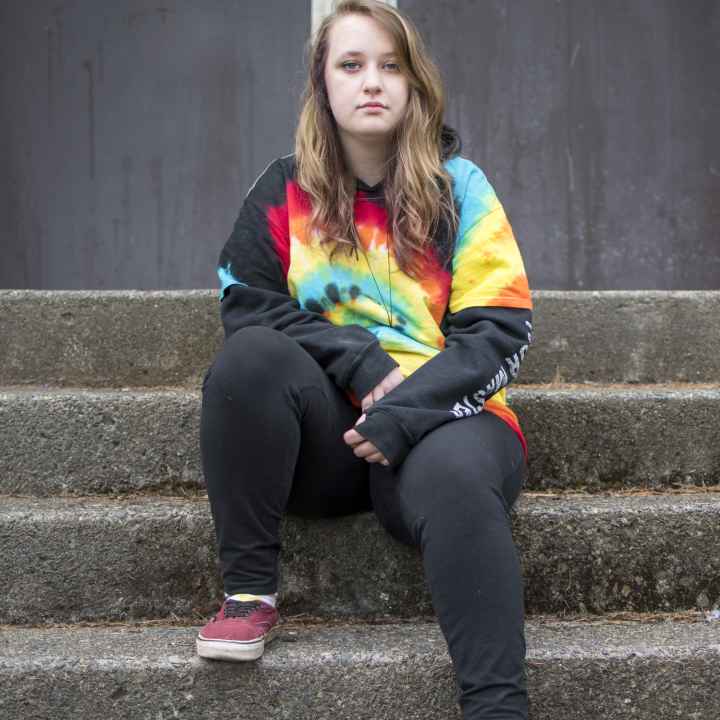 Liv Funk sits on the steps of North Bend High School