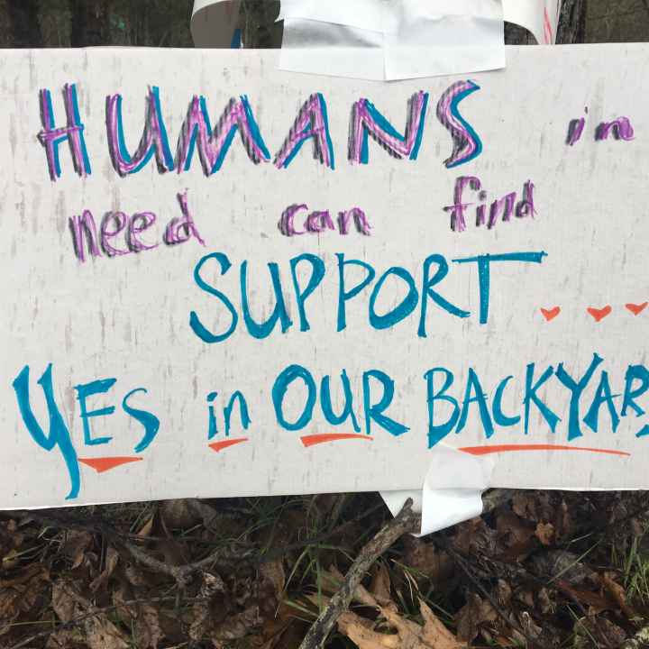 sign reads: Humans in need can find support...yes, in our backyard